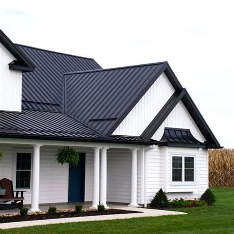 dark metal roof white house|house with black metal roof.